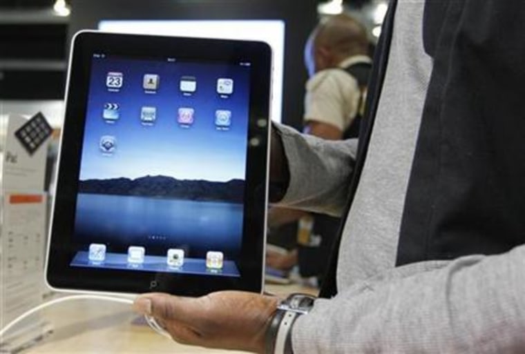 Salesman displays an Apple iPad during its launch in Brussels