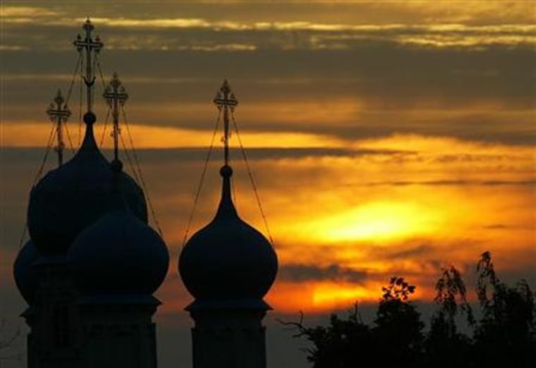 An orthodox cathedral is silhouetted as the sun sets in the village Zelyonaya Sloboda 50 km southeast from Moscow in this picture taken late on July 12, 2004.