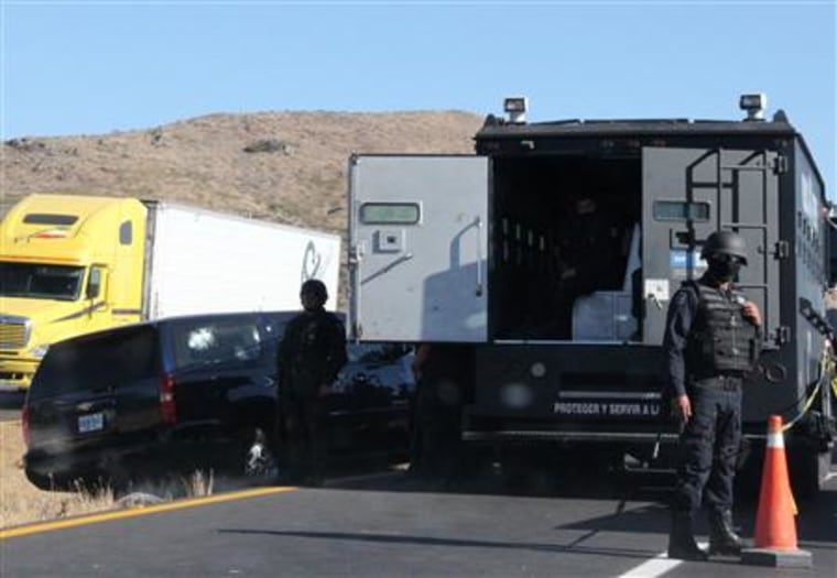 A car of U.S. Immigration and Customs Enforcement agents is seen next to a truck in Ojo Caliente