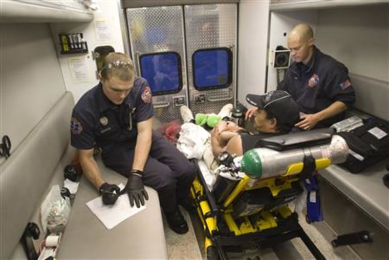 Members of a North Las Vegas Fire Department rescue unit care for a patient as he is transported to a hospital in Las Vegas
