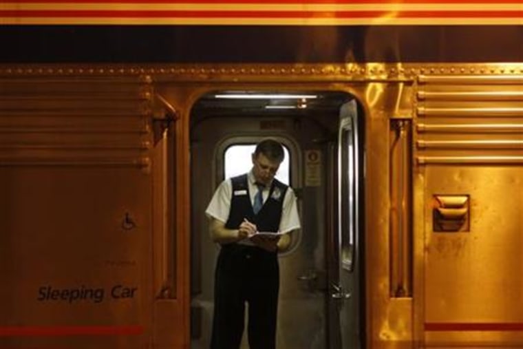 An Amtrak train attendant looks over paperwork on the 5 California Zephyr train in Chicago
