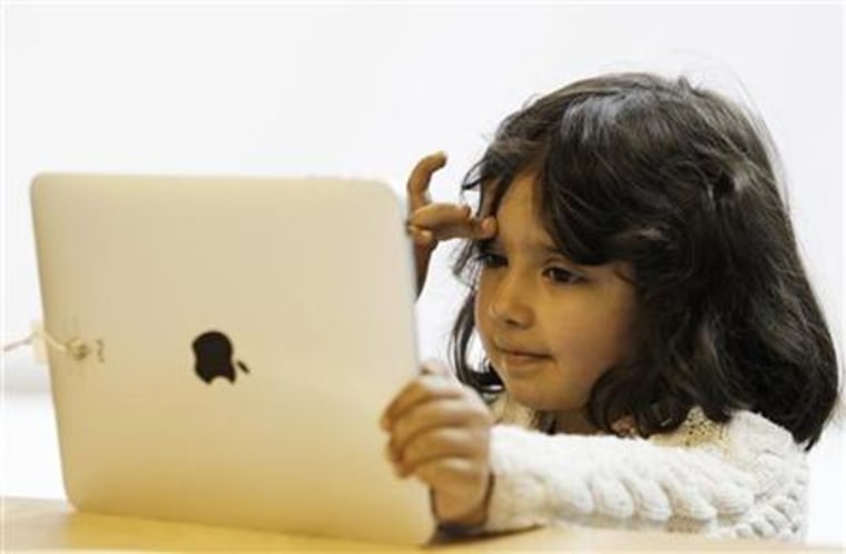 A girl views a new iPad tablet computer at an Apple store during its UK launch in central London