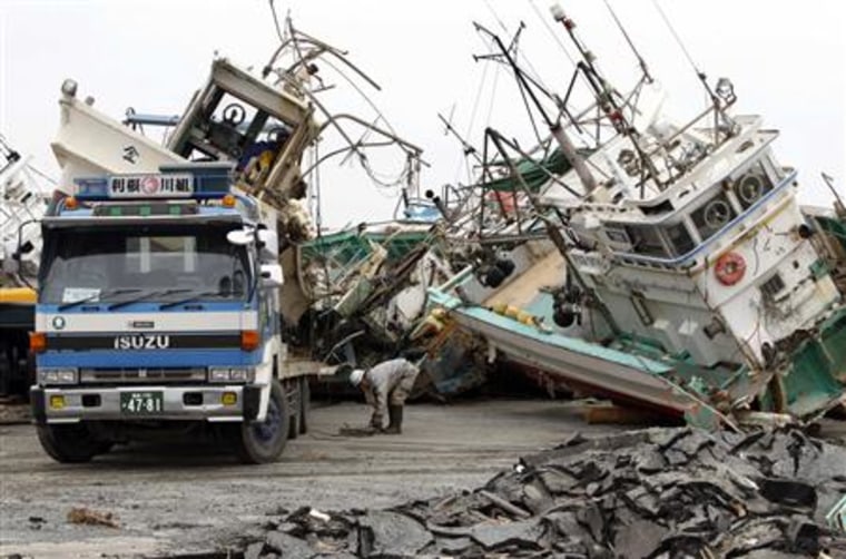 Crushed fishing boat which were devastated by the March 11 earthquake and tsunami are collected in Soma