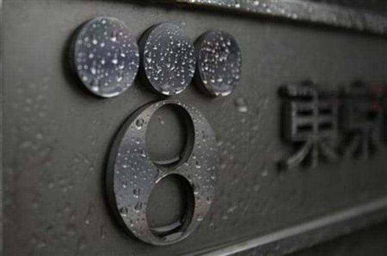 Raindrops are seen on the surface of a logo of Tokyo Electric Power at its headquarters in Tokyo