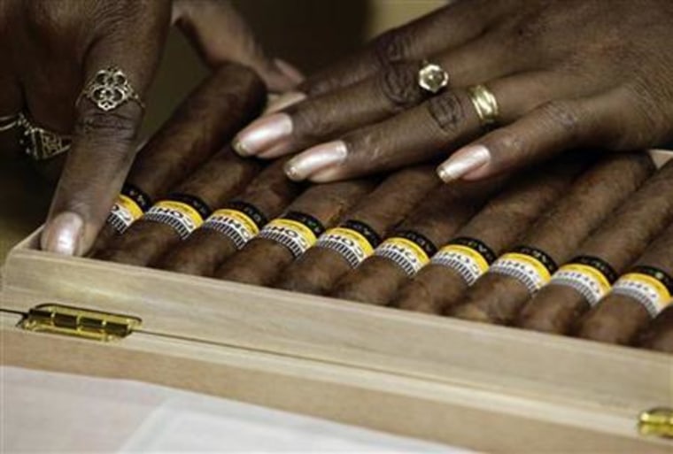 A worker fits Cohiba cigars in a box at the Partagas factory in Havana