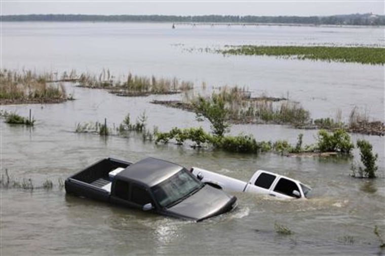 Vehicles sit stranded in flood waters in rural Missouri Valley, Iowa