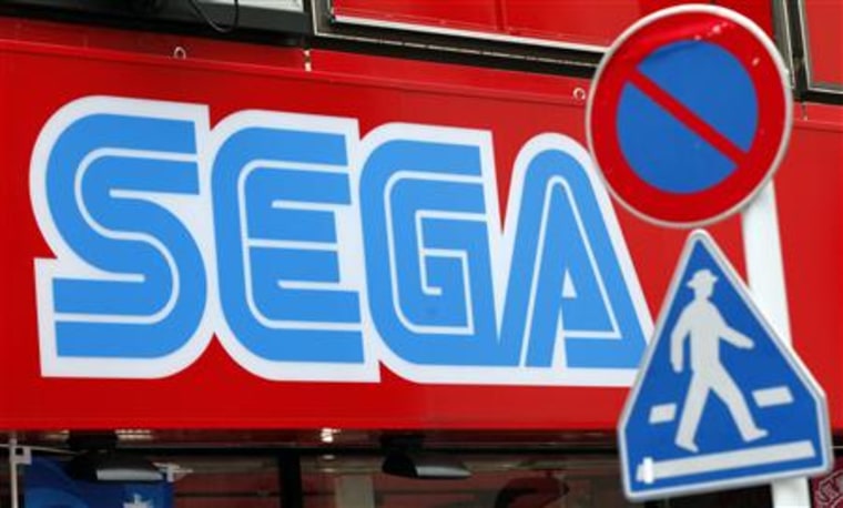 A Sega Corp signboard is seen behind traffic signs at the Akihabara electronic store district in Tokyo