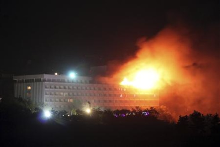 Smoke and flames rises from the Intercontinental hotel during a battle between NATO-led forces and suicide bombers and Taliban insurgents in Kabul
