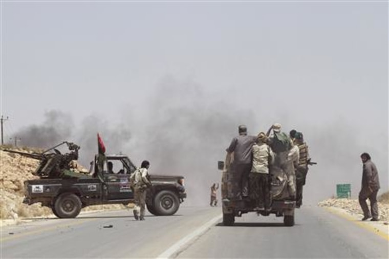 Rebel fighters enter the village of Al-Qawalish