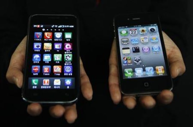 A Samsung Electronics' Galaxy S smartphone and an Apple Inc's iPhone 4 smartphone are seen in this picture illustration taken in Seoul