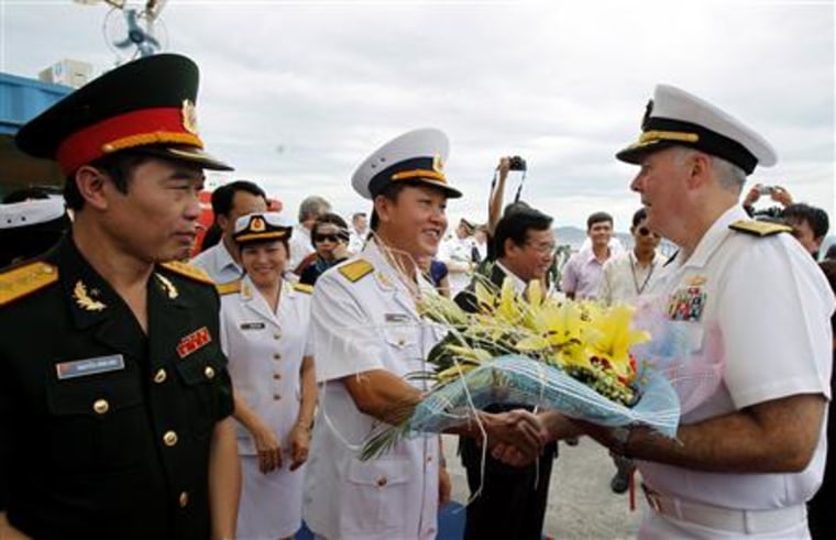 Colonel Nguyen Van Lam greets Rear Admiral Carney during a welcoming ceremony in Vietnam's central Danang city