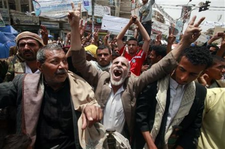 Anti-government protesters shout slogans during a rally to demand the ouster of Yemen's President Ali Abdullah Saleh at Tagheer square in Sanaa