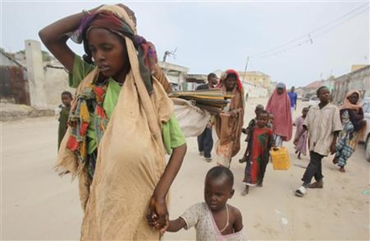 Internally displaced families arrive at a new settlement in Somalia's capital Mogadishu