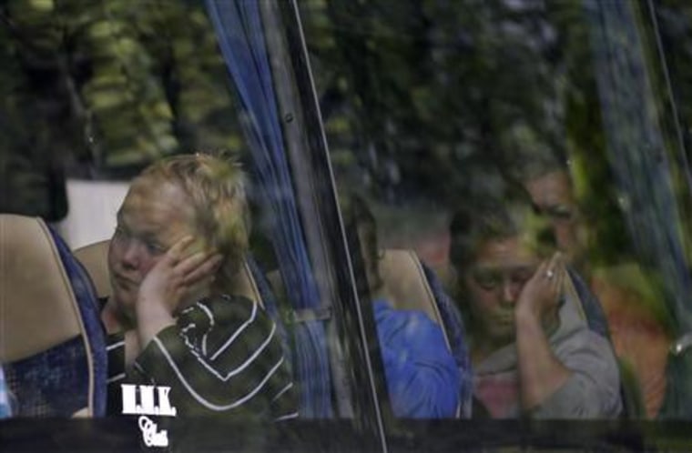 Survivors sit in a bus before leaving a hotel in Sundvollen