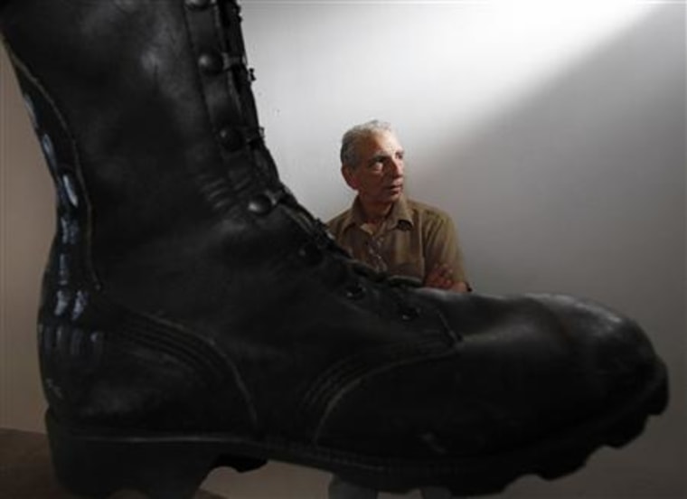 Joe Fornelli, artist liason for the National Veterans Art Museum, is seen beside Jon Turner's Prayer Boots in Chicago