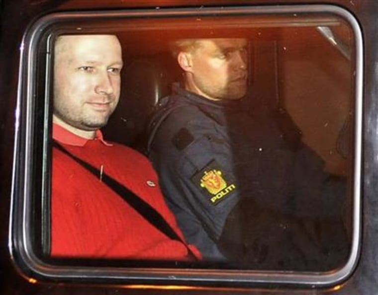 Breivik, man accused of a killing spree and bomb attack in Norway, sits in the rear of a vehicle as he is transported in a police convoy in Oslo