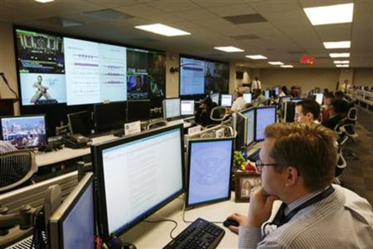 U.S. Department of Homeland Security analysts work at the National Cybersecurity & Communications Integration Center in Arlington Virginia