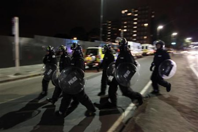 Police officers in riot gear are deployed in Eltham, south London