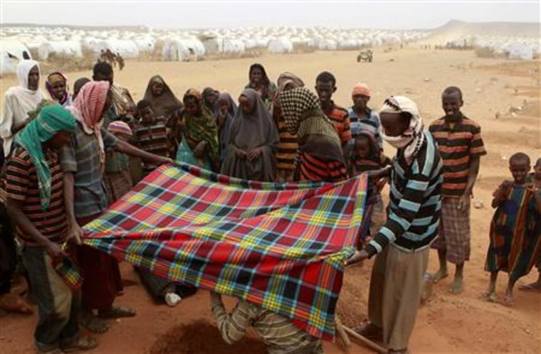 Recently arrived refugees from Somalia bury the body of Sahro at the Kobe refugee camp