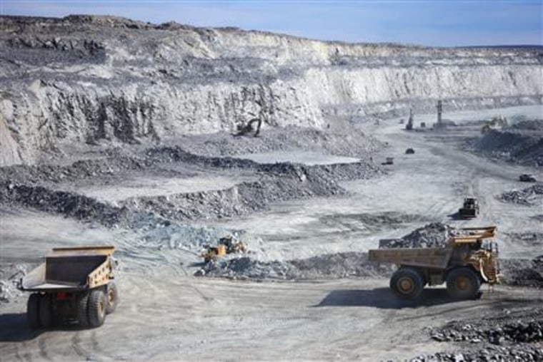 Hydraulic excavators scoop the broken rock into 100- or 150-tonne haul trucks at Agnico-Eagle's Meadowbank Mine in Nunavut, Canada