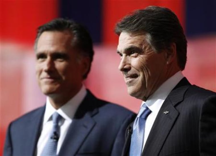 Perry and Romney stand next to each other onstage during a photo opportunity before the Reagan Centennial GOP presidential primary debate in Simi Valley