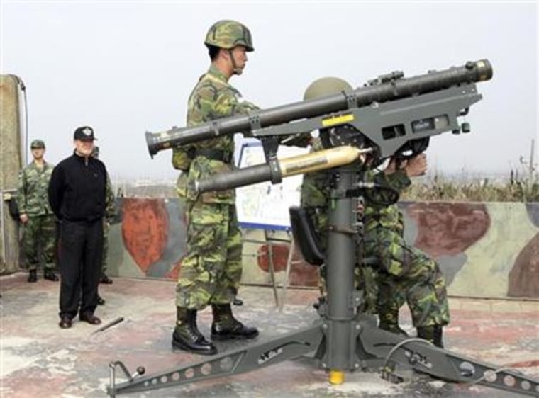 Handout photograph shows army soldiers demonstrating anti-air weaponry to Taiwan's Defence Minister Kao during a military exercise in Penghu