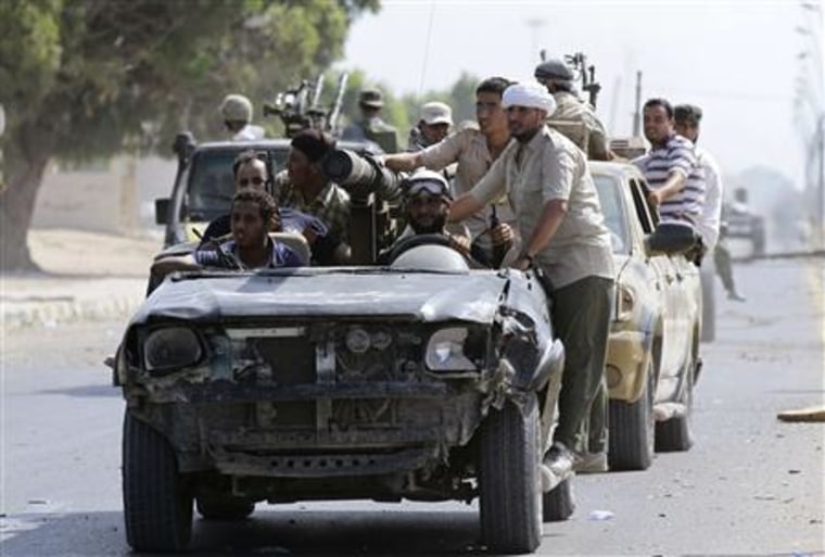 Fighters loyal to Libya's interim rulers circle near the front line from the centre of the city of Sirte