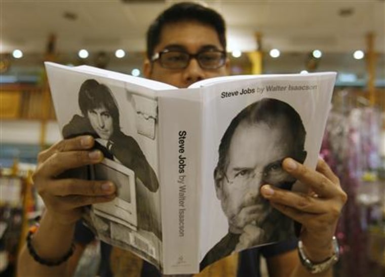 An Apple fan browses through the biography of Steve Jobs, sold at a bookstore in Quezon City