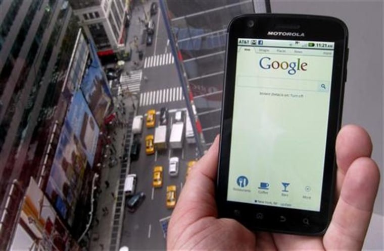 A posed picture shows a Motorola Droid phone displaying the Google search page in New York