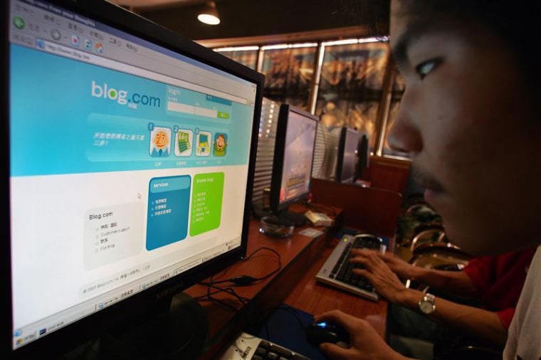 Man surfs on internet blog at internet bar in Shanghai