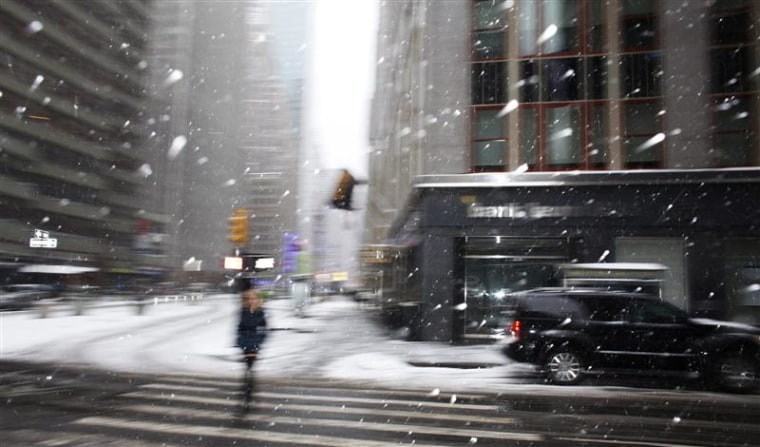 A woman walks during a snow storm in New York