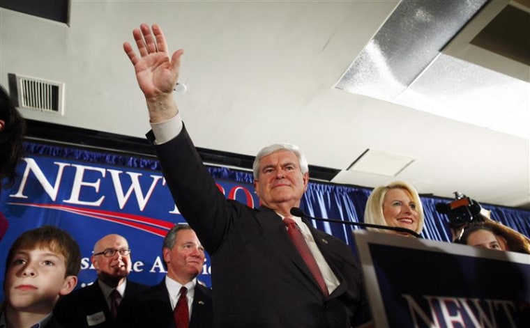 Republican U.S. presidential candidate Gingrich waves to the crowd with his wife Calista at right at his South Carolina primary election night rally in Columbia