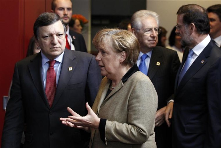 Jose Manuel Barroso and Angela Merkel are followed by Mario Monti and Mariano Rajoy as they arrive at a family photo during an European Union summit in Brussels