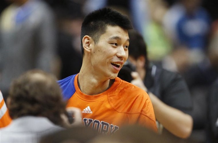 Knicks guard Lin smiles during player introductions before the start of the Knicks' NBA basketball game against the Timberwolves in Minneapolis