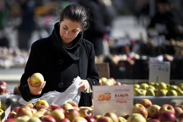 A woman shops for apples at a farmer's market in Union Square in New York