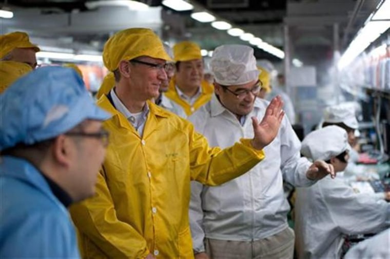 Handout photo shows Apple CEO Cook talking to employees as he visits the iPhone production line at the new Foxconn Zhengzhou Technology Park in Henan