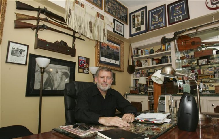 McDowell, retired after 30 years in the US Army, sits in his study with framed battalion patches from tours in Iraq and Afghanistan, in Columbia