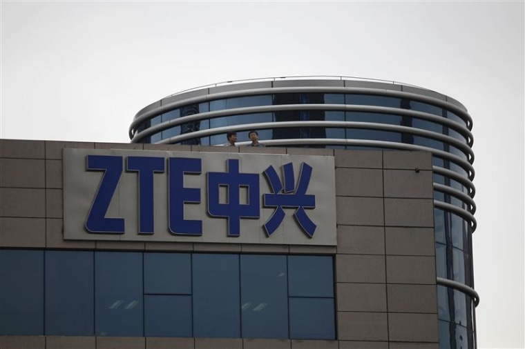 Employees of ZTE chat on the roof of its headquarters in Shenzhen, Guangdong province