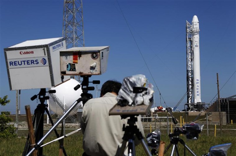News photographers work on their remote cameras as the SpaceX Falcon 9 test rocket is being prepared for a second launch attempt at the Cape Canaveral Air Force Station in Cape Canaveral