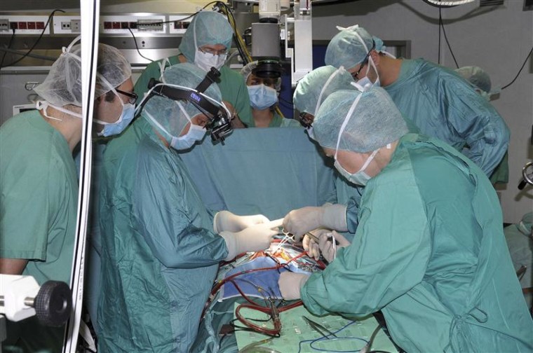 Handout picture shows heart surgeons implanting the world's smallest artificial heart, in a baby, in Rome