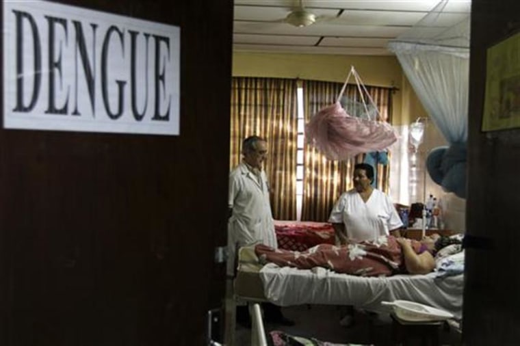 A patient lies on a bed in a ward reserved for people suffering from dengue fever in a hospital at Barrio Obrero district in Asuncion