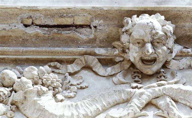 Spots where pieces have fallen off the top of the Trevi Fountain are seen in Rome