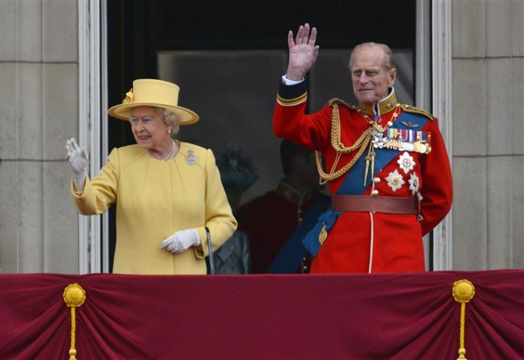 Britain's Queen Elizabeth and her husband Prince Philip stand on the balcony of Buckingham Palace following the Trooping the Colour ceremony in central London