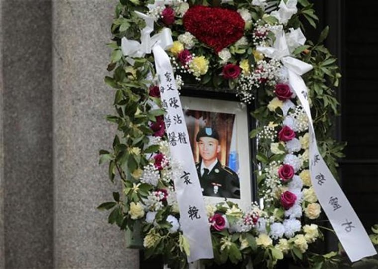 A portrait of U.S. Army Private Danny Chen is displayed during his funeral procession in New York