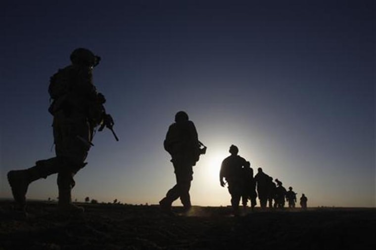 U.S. Army soldiers are silhouetted as they walk during a mission in the Maiwand district of Kandahar province, southern Afghanistan