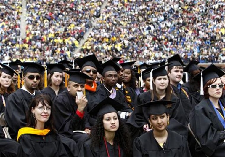 Graduating students listen to U.S. President Obama speak during commencement at the University of Michigan