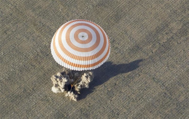 The Soyuz TMA-04M capsule carrying the International Space Station (ISS) crew lands near the town of Arkalyk in northern Kazakhstan