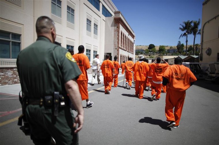 File photograph of Inmates escorted by a guard through San Quentin state prison