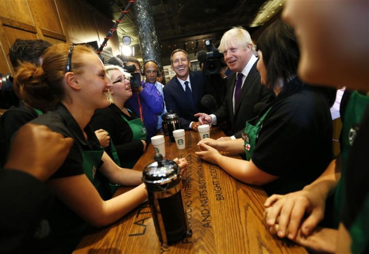 London Mayor Boris Johnson and Starbucks CEO Howard Schultz chat to apprentice barristas in the company's Mayfair Vigo Street branch in central London