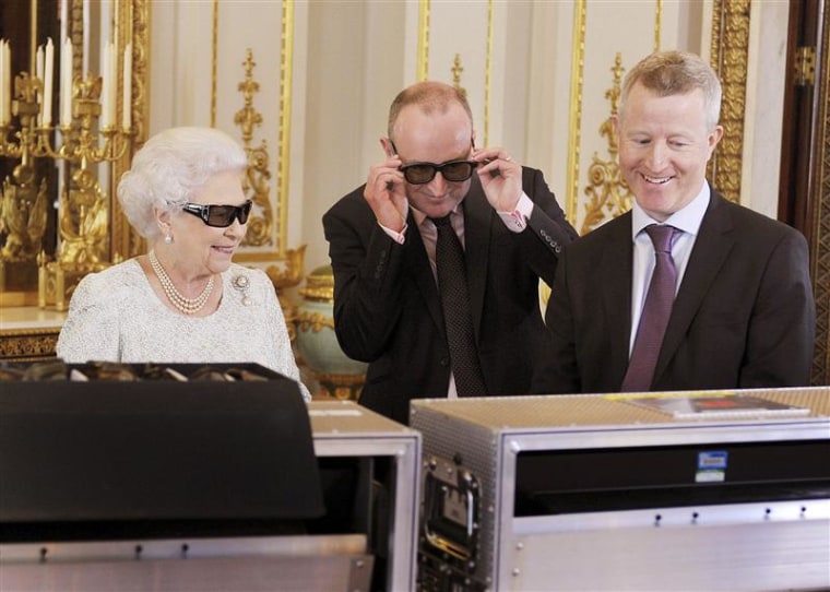 Britain's Queen Elizabeth watches a preview of her Christmas message with a pair of 3D glasses in London